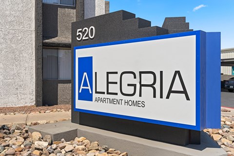 a sign in front of a building that says allegra apartment homes